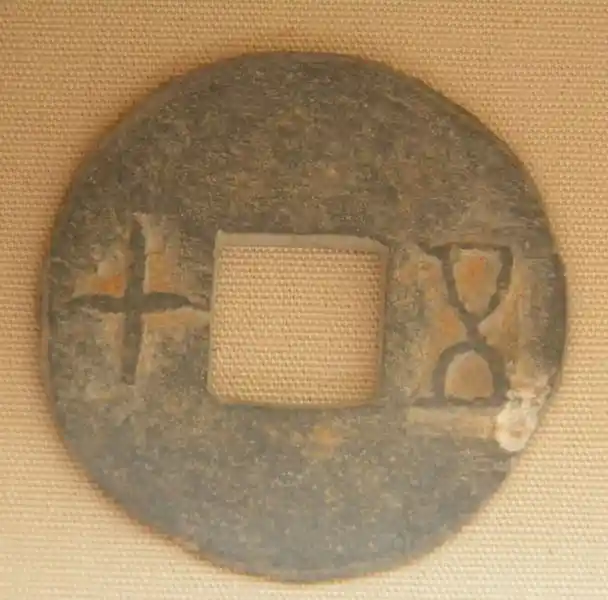 Money for the dead, coined-shaped charms